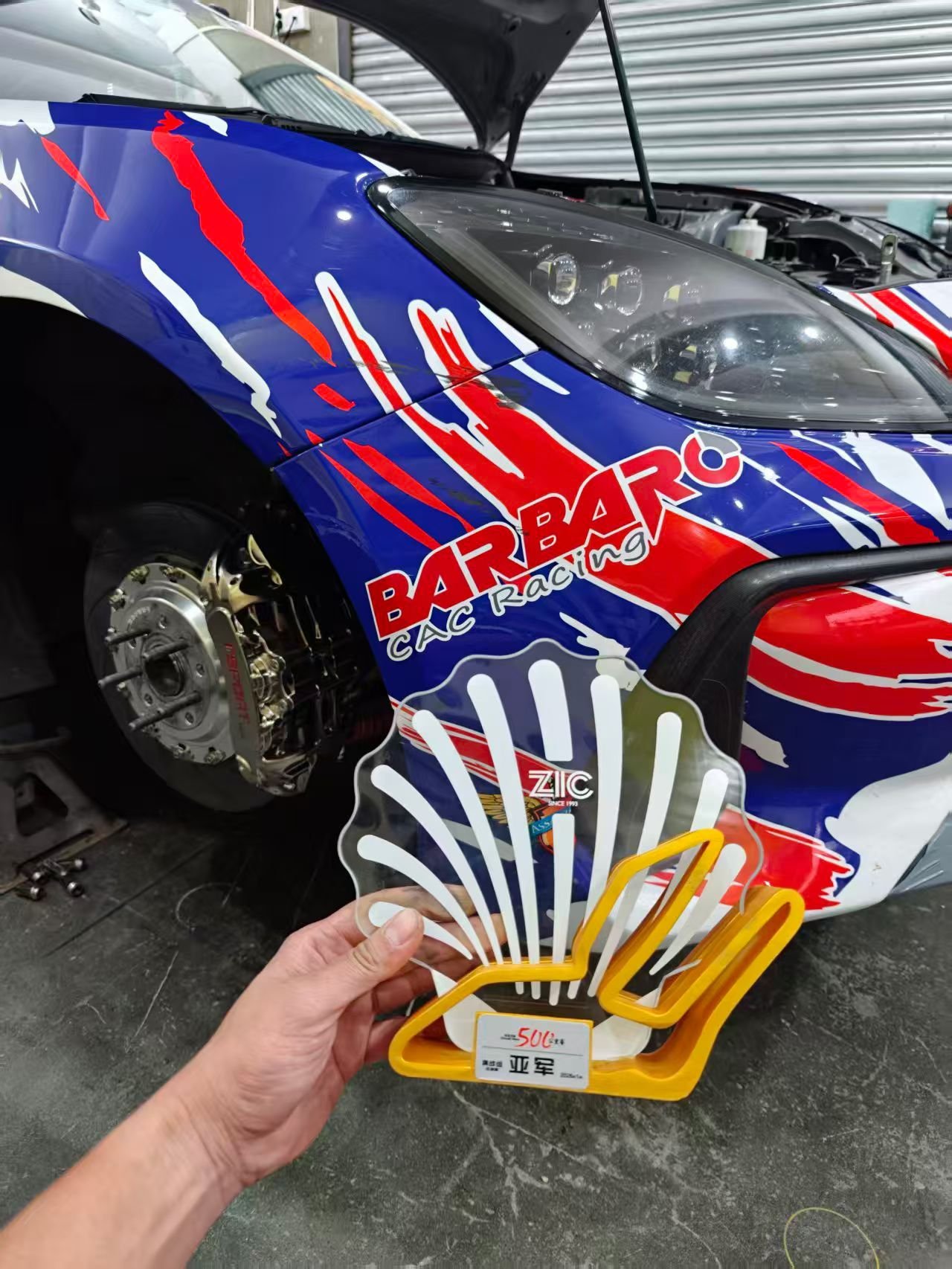 Barbaro CAC Racing team with race car and 500km endurance runner-up trophy