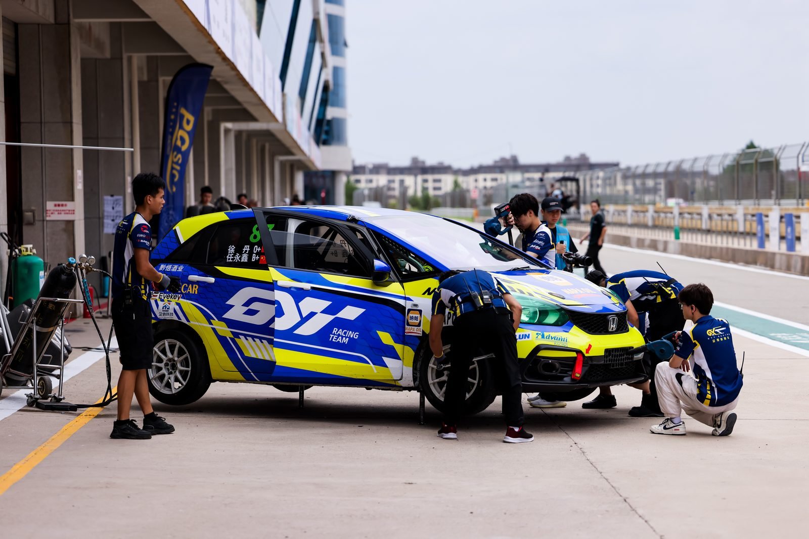 Pit crew inspecting brakes