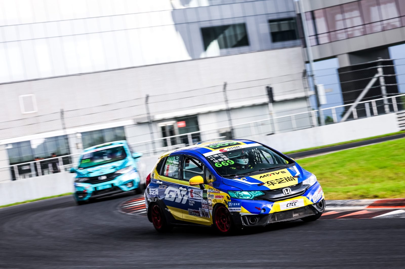 Race cars battling through a corner